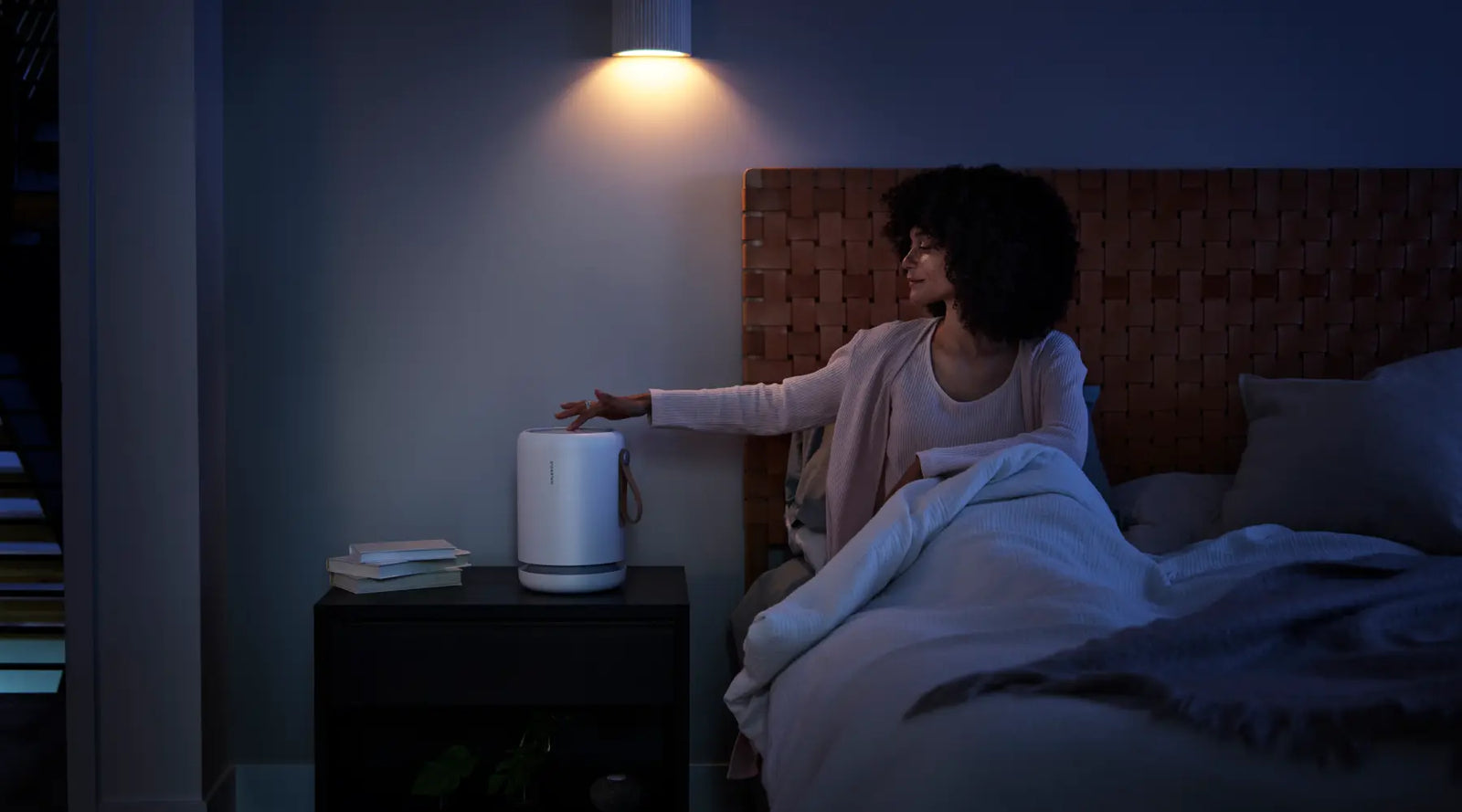 A woman in bed is about to go to sleep.