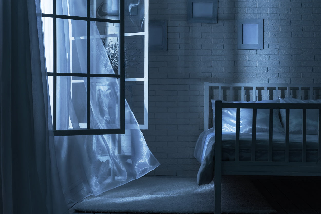 Clean air flowing into a dark bedroom through an open window