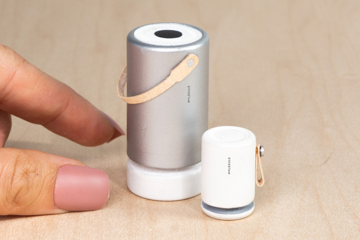Tiny model Molekule Air Pro and Molekule Mini+ with pink nail polish fingers