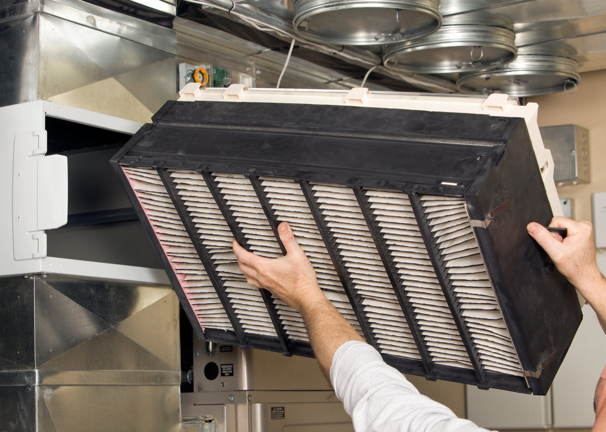 Person removing home HVAC filter