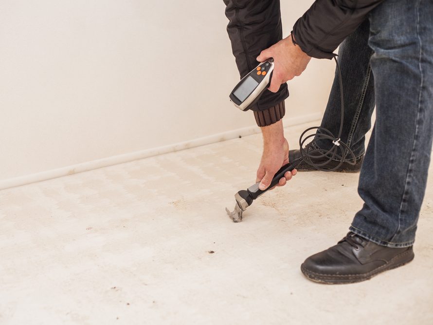 What is relative humidity in a home article- man measuring with a meter