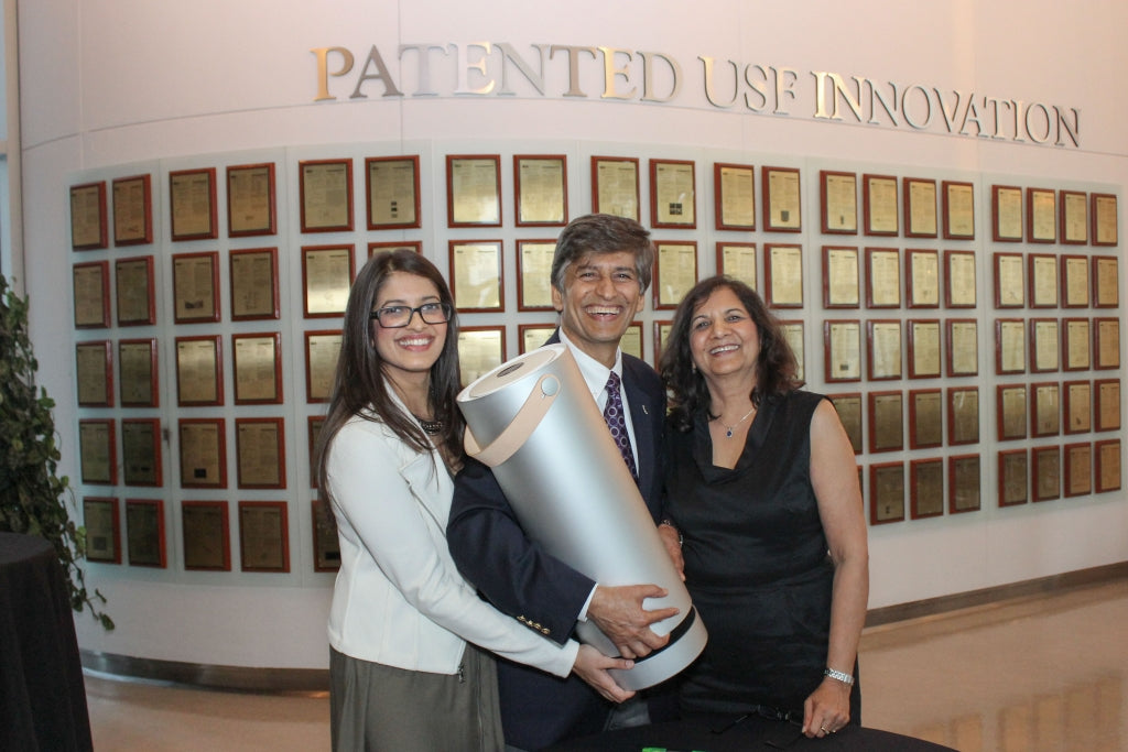 Yogi Goswami holding the new Molekule air purifier, standing alongside Jaya Rao and Lovely Goswami