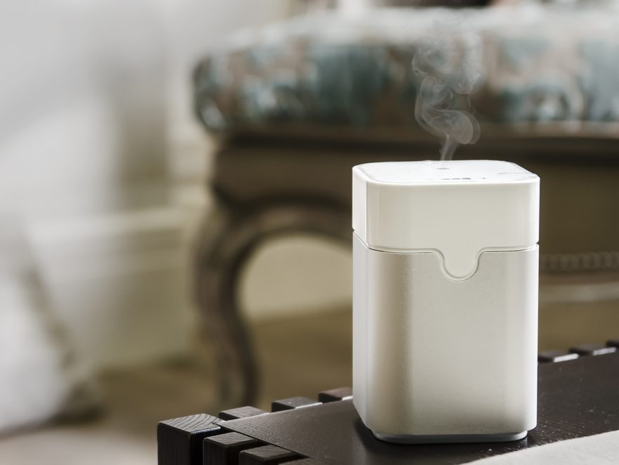 White-colored ultrasonic humidifier atop a table