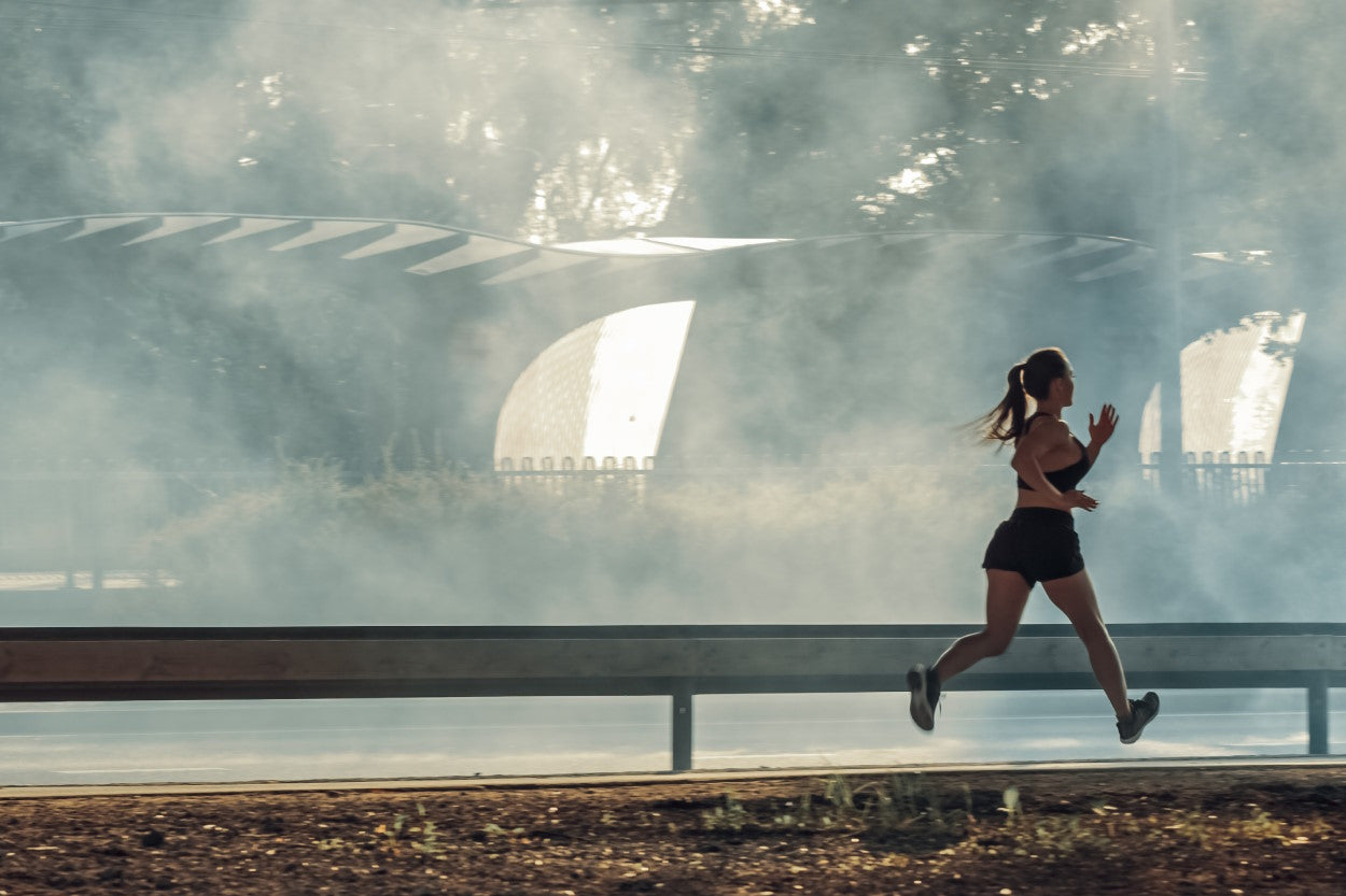 Woman running in foggy weather