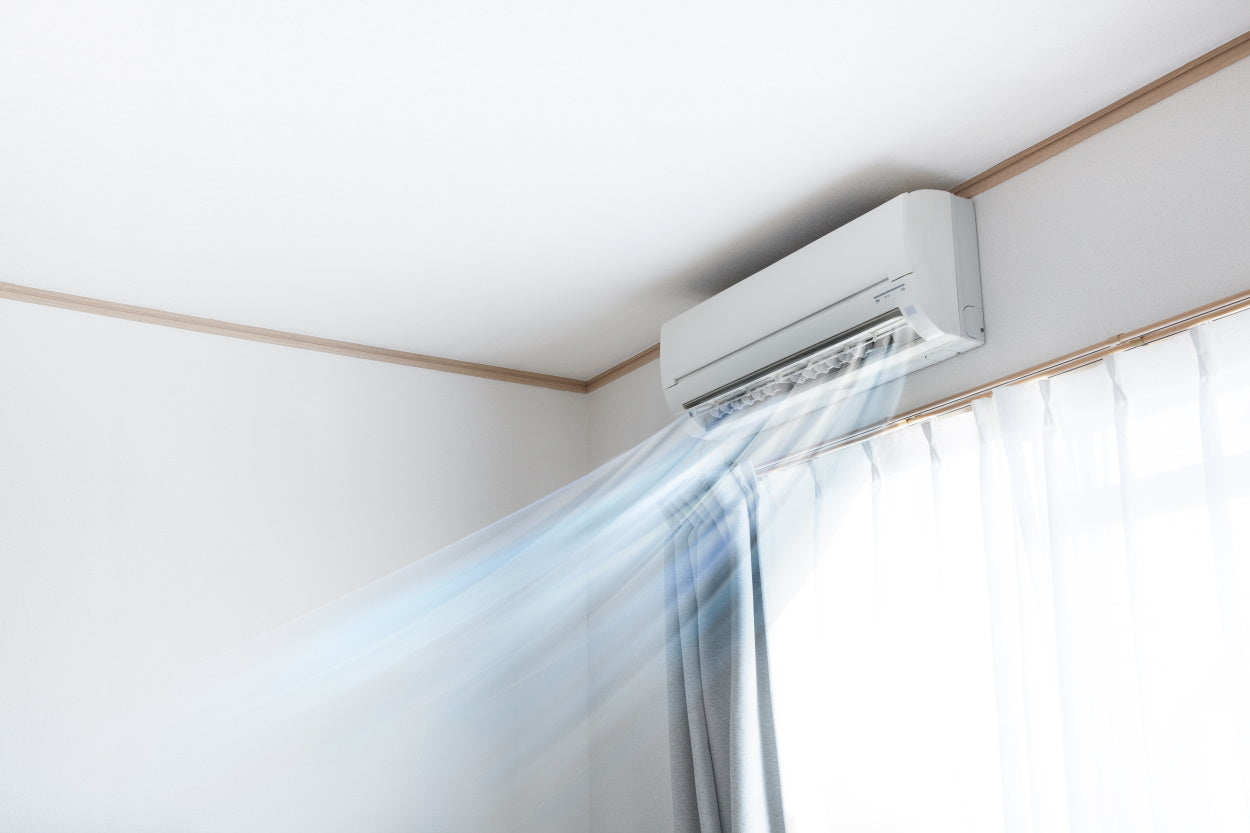 Cool air flowing from a wall-mounted air conditioner