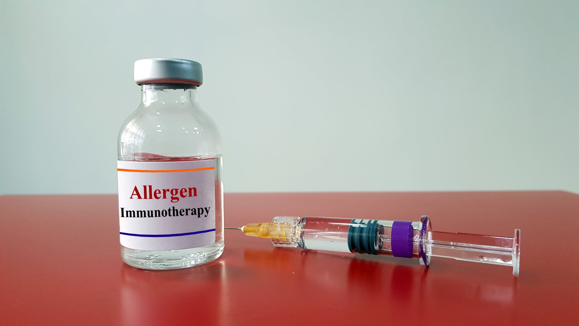Syringe needle next to vial labeled 'Allergen Immunotherapy'
