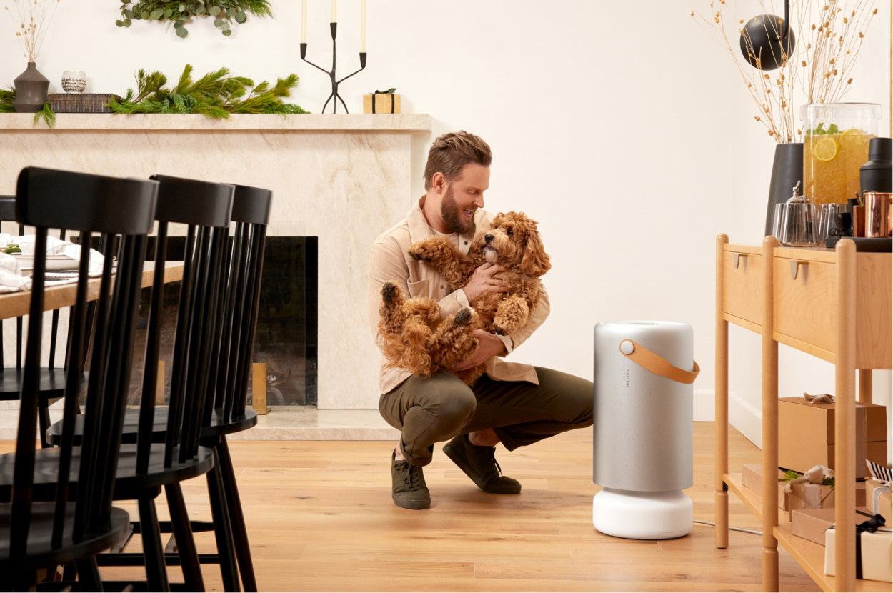 Bobby Berk with a puppy and Molekule Air Pro