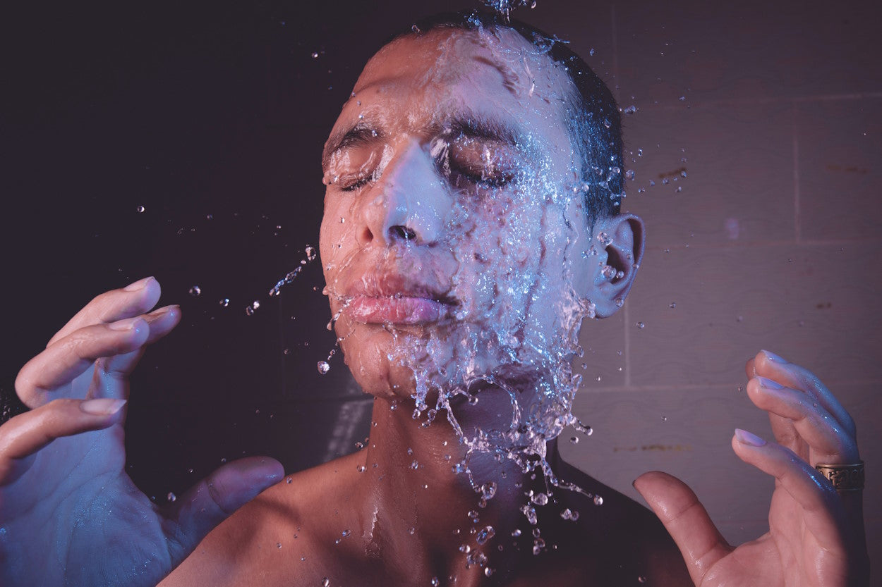 A man splashing water on his face