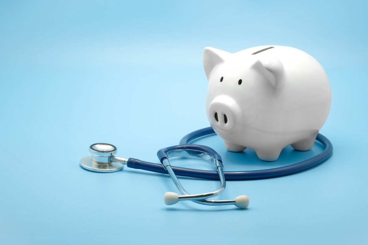 Piggy bank circled by a stethoscope 
