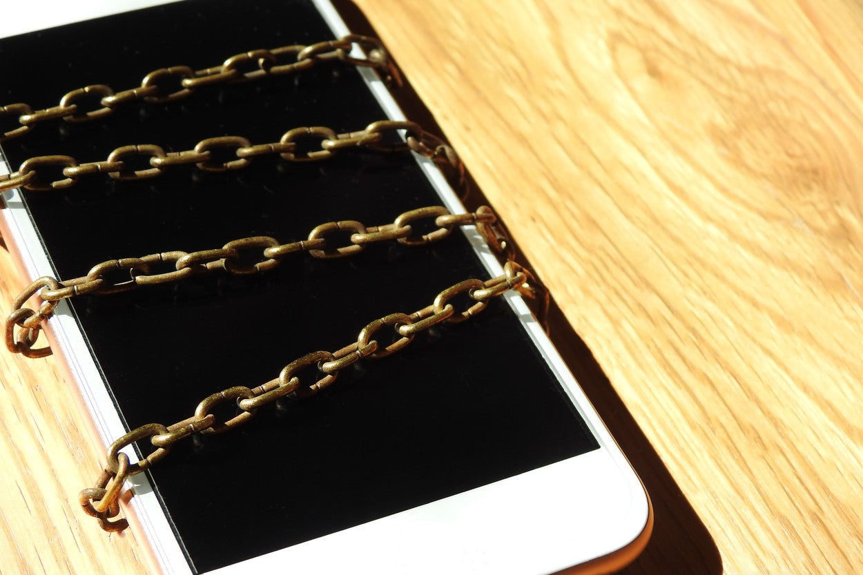 Cellphone wrapped in metal chains