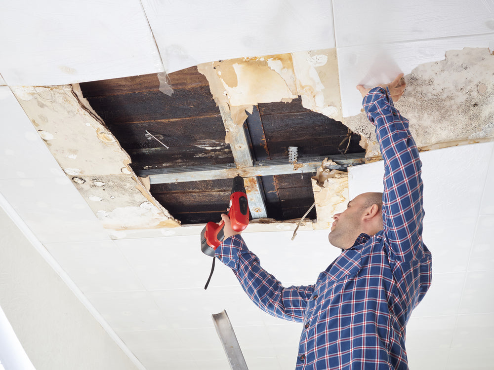 Man discovering asbestos during home renovation
