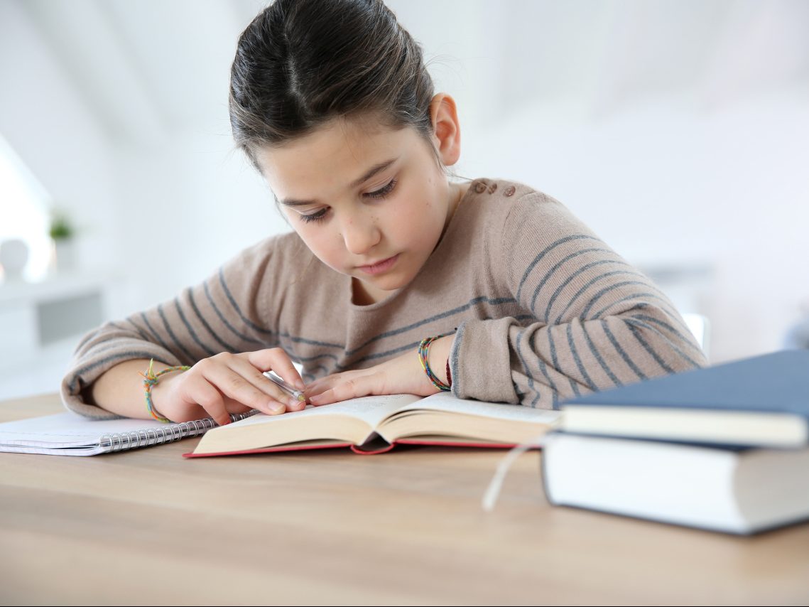 Child studying with a book