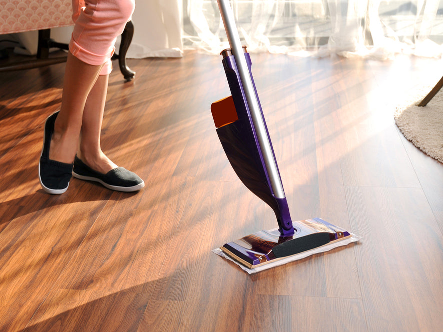 Woman's feet while she mops a hardwood floor