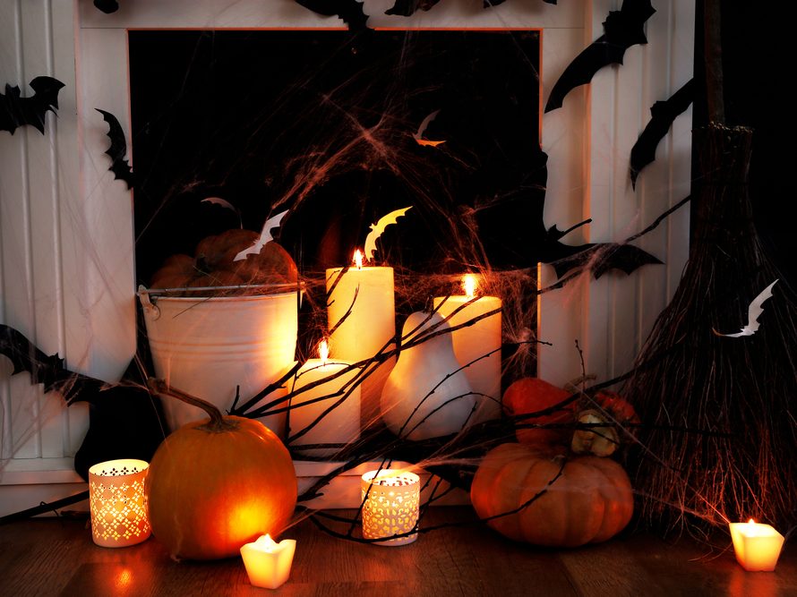 Halloween hearth with candles, pumpkins, and bat decorations