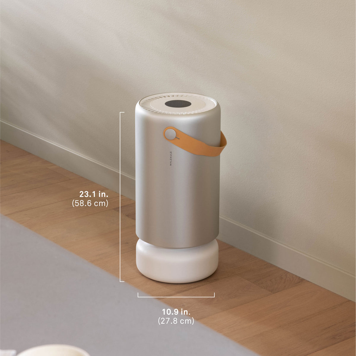 A Molekule Air Pro air purifier sits in an open concept room of a modern home. It measures 23.1 inches tall (58.6cm) and 10.9 inches wide (27.8 cm) and deep.