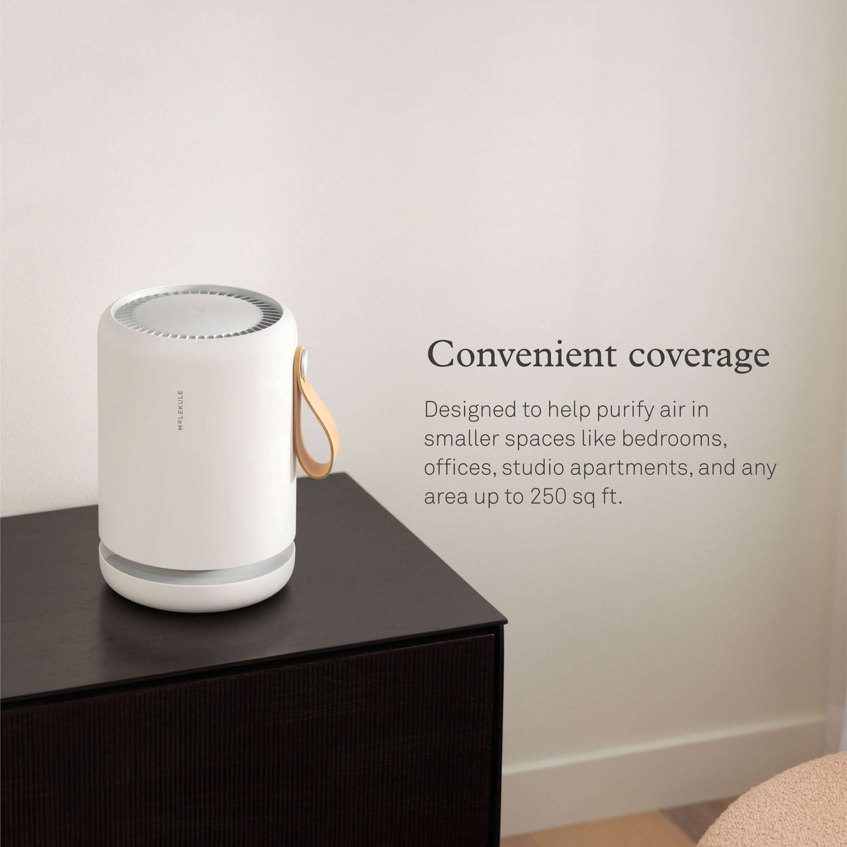 Molekule Air Mini air purifier on a table. Convenient coverage. Designed to help purify air in smaller spaces like bedrooms, offices, studio apartments, and any area up to 250 sq ft.